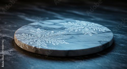 Elegant winter concept with a circular marble podium featuring intricate white snowflake patterns for product display on a dark background