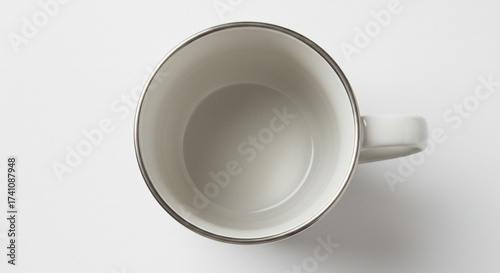 Top-down view of an empty white ceramic coffee mug with a dark rim, isolated on a clean white background