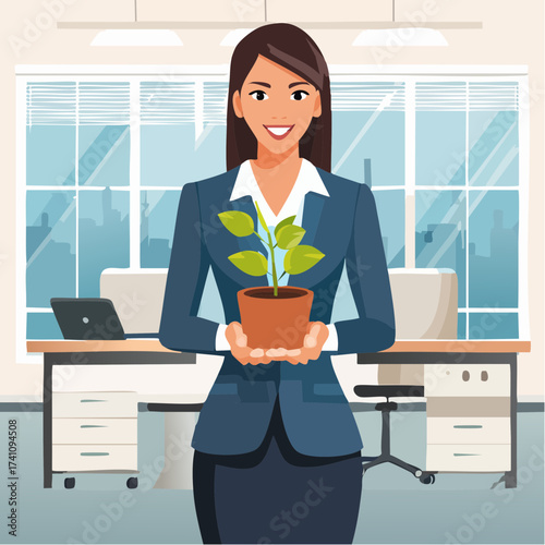 A smiling businesswoman in a blue suit holding a potted plant in a modern office setting with a desk and laptop.
