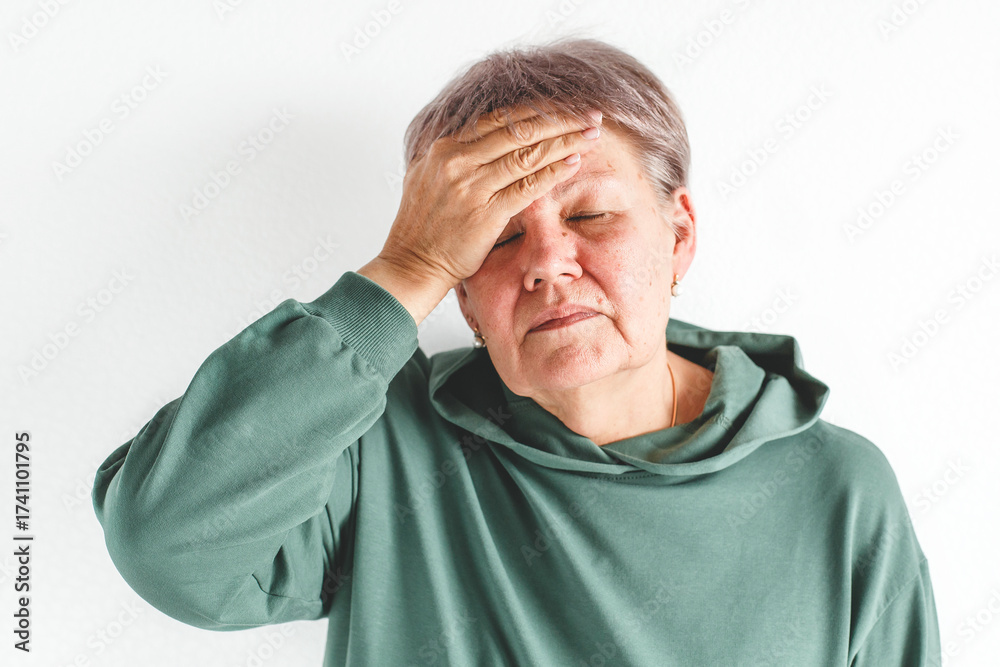 Εκτύπωση καμβά Isolated portrait of senior white woman with short gray haircut in green hoodie