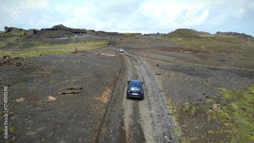 Car driving through wild volcanic Icelandic landscape, view from above