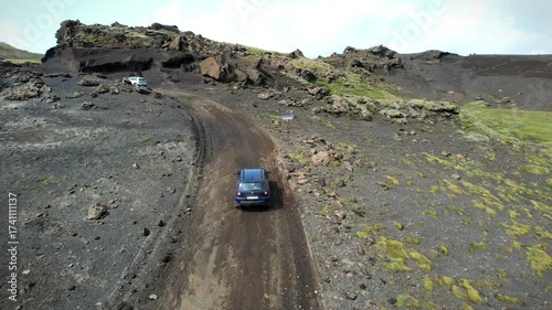 Car driving through wild volcanic Icelandic landscape, view from above