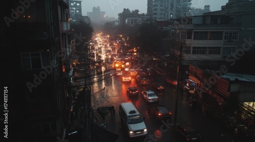 City street scene during a rainstorm at night with heavy traffic