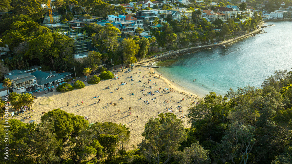 Αυτοκόλλητο Stunning panoramic views of Manly Beach with soft golden sands and gentle waves glistening beneath the clear blue sky