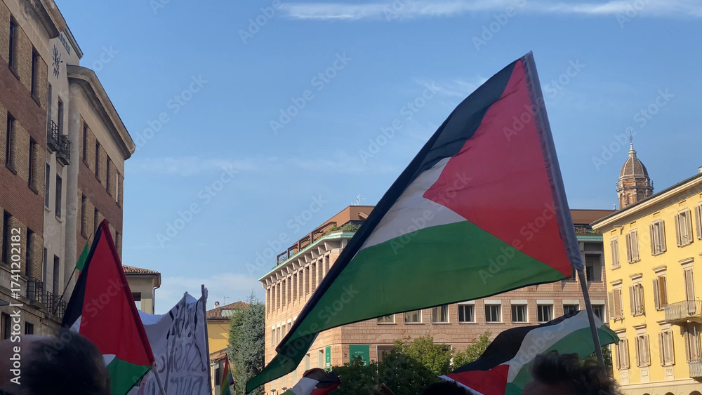 Fototapeta premium Thousands of activists and concerned citizens gathered in Cremona Lombardy Italy holding Palestinian flags and peace banners demonstrating solidarity with Gaza