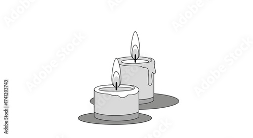 Two burning candles casting a warm glow in the dark.