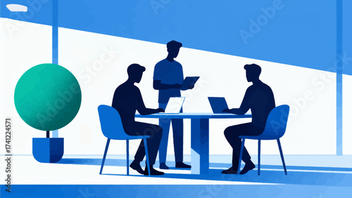 Three people working at a table with laptops