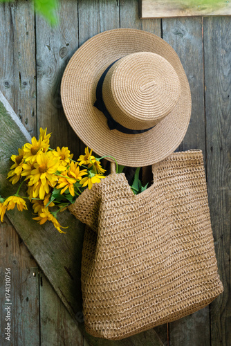 Wild flowers in a beautiful straw bag and a straw hat.
