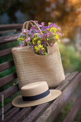 Wild flowers in a beautiful straw bag and a straw hat.