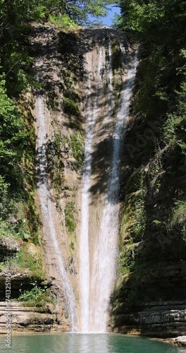 8K vertical waterfall from Erfelek in Sinop, Turkey, cascading powerfully through green forest cliffs. The crystal water flow contrasts beautifully with the lush moss-covered rock
