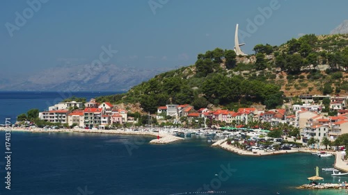 Wallpaper Mural Summer day on the beautiful waterfront of Podgora, a travel destination on the Croatian Riviera. The scenic seaside is lined with houses and a marina filled with moored yachts and boats. Torontodigital.ca