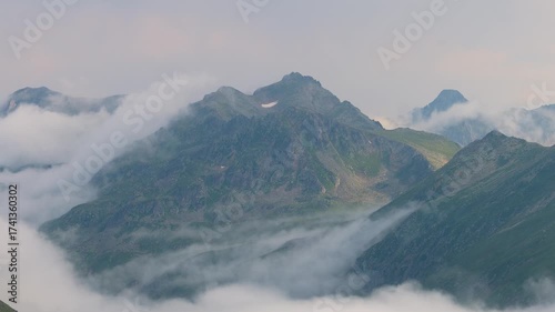 8K horizontal footage of fog drifting slowly along the slopes of the Kaçkar Mountains. The soft movement of mist gives a poetic, cinematic mood ideal for film or documentary scenes. Camlihmesin, Rize