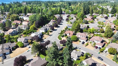 Circling high above a Seattle suburban neighborhood on a sunny summer day, with a view of Puget Sound in the distance