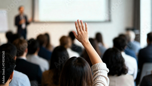 Engaged attendee raising hand, a concept on participation, inquiry, and contribution. Q&A Session