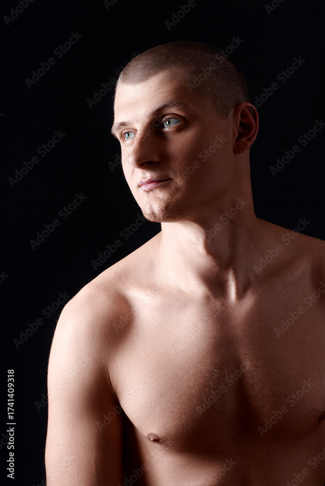 Naklejka premium Young Man Posing Confidently Against Dark Background