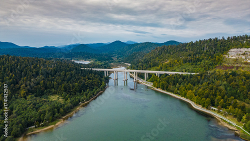 Panoramic aerial view of the toll highway (Autocesta A6) bridge near Fužine (Fuzine) and Lake Bajer in Gorski Kotar, Croatia, surrounded by green mountains and forests