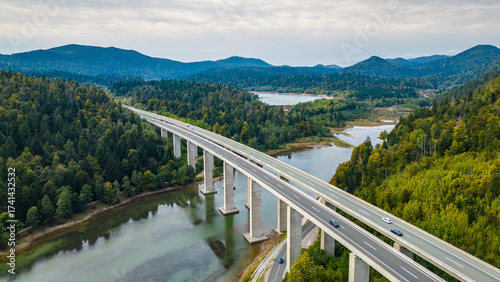 Panoramic aerial view of the toll highway (Autocesta A6) bridge near Fužine (Fuzine) and Lake Bajer in Gorski Kotar, Croatia, surrounded by green mountains and forests
