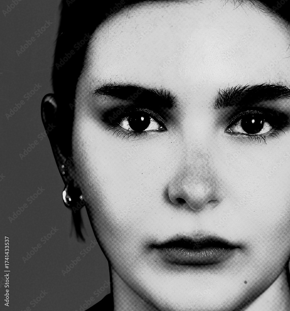 Fototapeta premium Face of a beautiful young woman in closeup in black and white monochrome with halftone effect