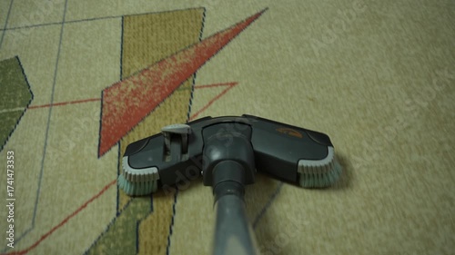 Houseworker with vacuum cleaner cleaning carpet at home. Housework and housekeeping concept. POV of use vacuum cleaner. Camera mounted on hoover