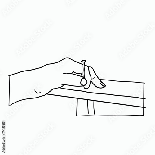 Skilled Hand Holding a Nail Precisely Positioned Over a Piece of Wood for Detailed Carpentry and Woodworking Craftsmanship