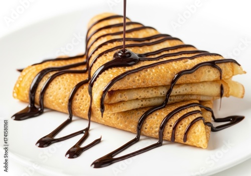 Stack of golden crepes drizzled rich chocolate sauce, isolated on white background