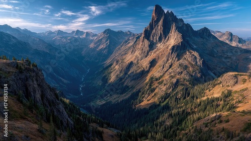 Fototapeta Naklejka Na Ścianę i Meble -  High-altitude mountain landscape jagged peaks deep blue sky wispy clouds vast untouched wilderness adventure vibe
