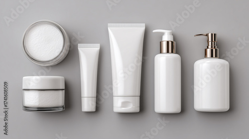 Flat lay of multiple skincare containers, including jars, tubes, and bottles, arranged symmetrically on a seamless pale gray background. Soft studio lighting creates a clean, modern mockup ready for b