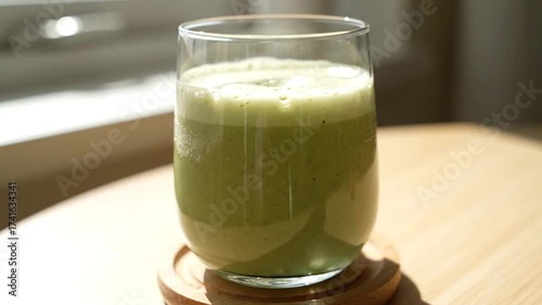 Vibrant Green Smoothie in a Glass on a Sunny Table, A Refreshing Health Drink