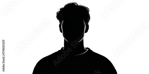 Intriguing silhouette of a young man against a stark white backdrop showcasing dramatic lighting and anonymity
