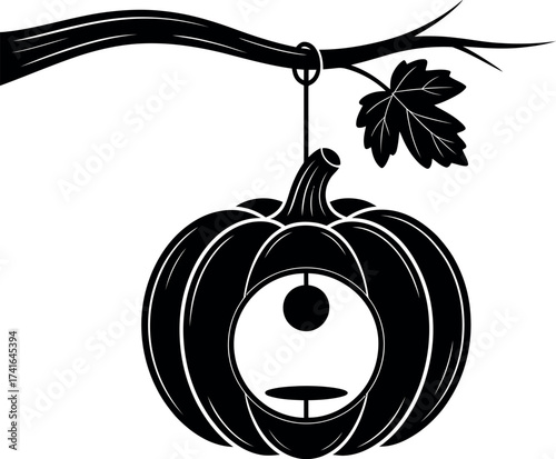Hanging pumpkin lantern on branch.