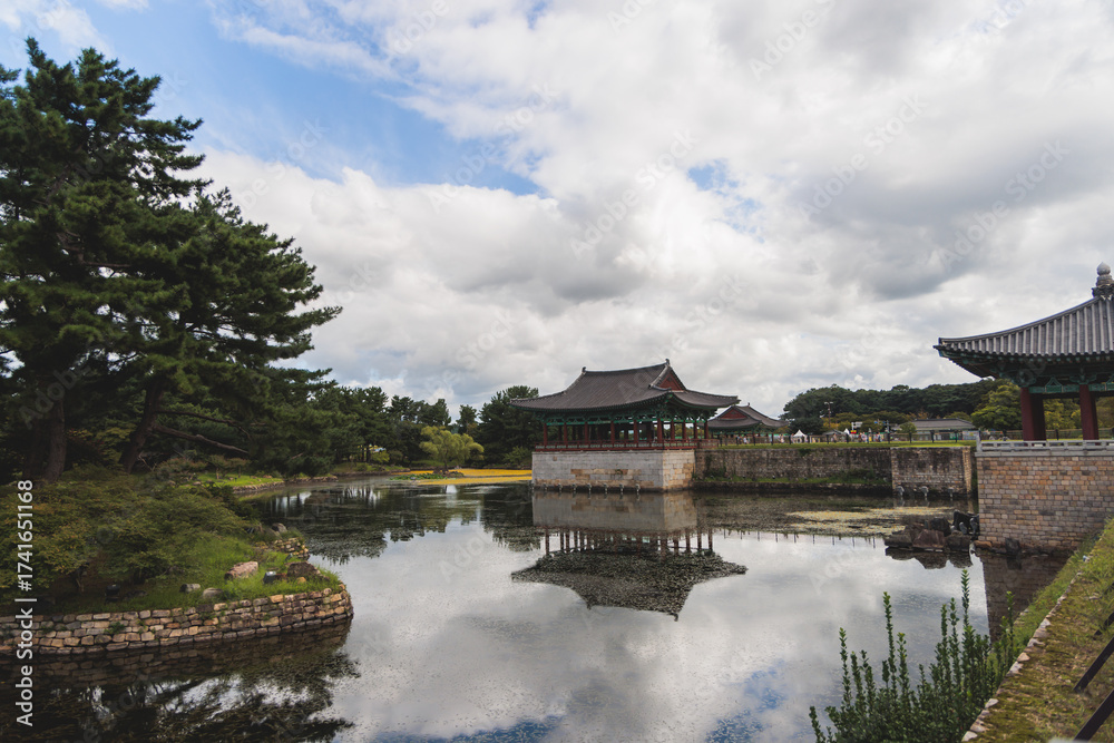 Naklejka premium Gyeongju, South Korea, view of Donggung Palace and Wolji Pond in a sunny day, North Gyeongsang Province, Gyeongju city, Silla dinasty traditional Korean hanok architecture, Yeongnam region