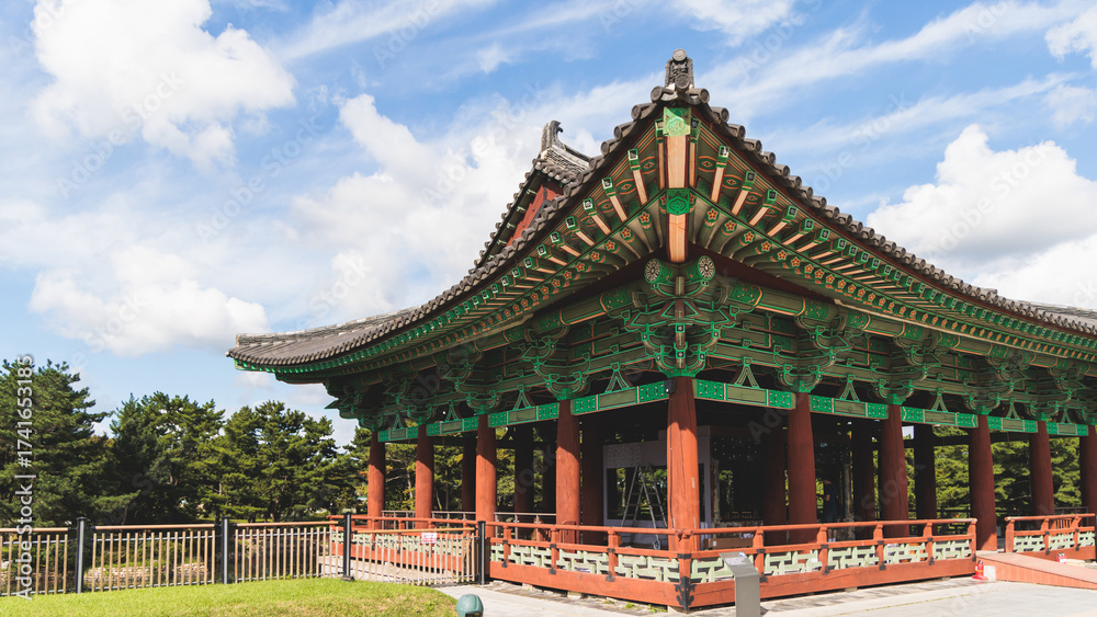 Fototapeta premium Gyeongju, South Korea, view of Donggung Palace and Wolji Pond in a sunny day, North Gyeongsang Province, Gyeongju city, Silla dinasty traditional Korean hanok architecture, Yeongnam region