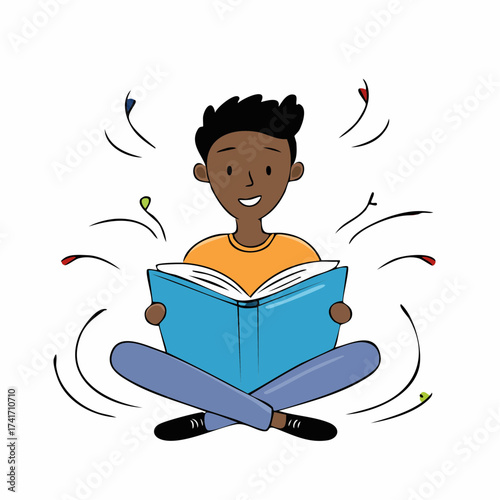 A young boy is engrossed in a book while sitting cross-legged