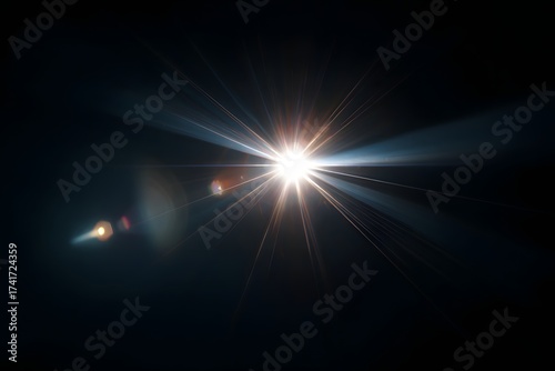 Bright starburst lens flare effect radiating intense light with subtle blue and orange hues against a deep black background