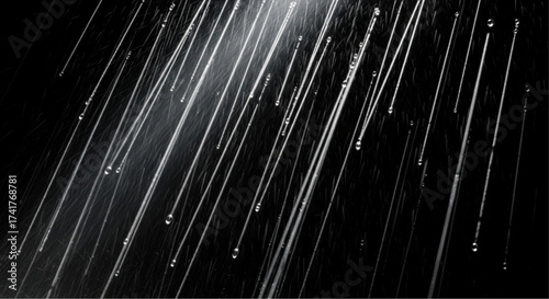 Abstract imagery of water droplets, captured with a unique perspective that focuses on the individual droplet, the play of light, and the darkness that accentuates the droplets' shimmer. 