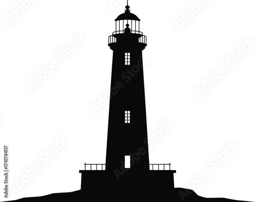 Tall lighthouse silhouette on rocky shore black white