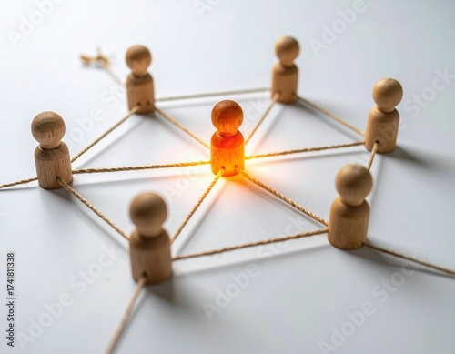 A creative representation of connection and collaboration using wooden figures and strings.