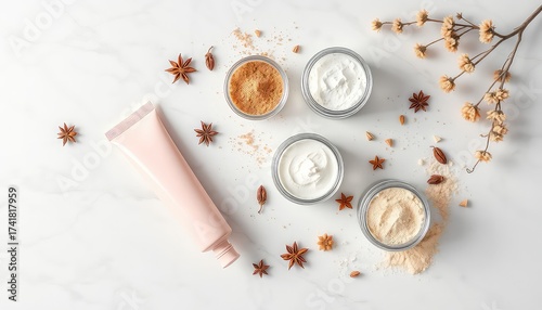 Delicate skin care products arranged aesthetically on a white marble surface with floral and spice accents, evoking luxury and natural beauty
