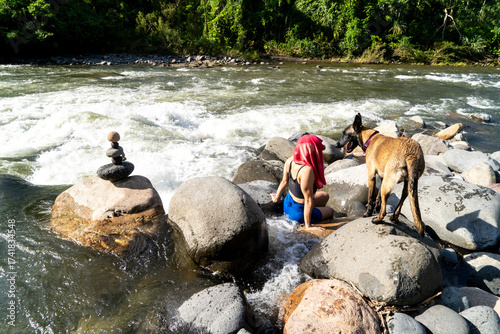 Lifestyle of a woman enjoying a river with her pet