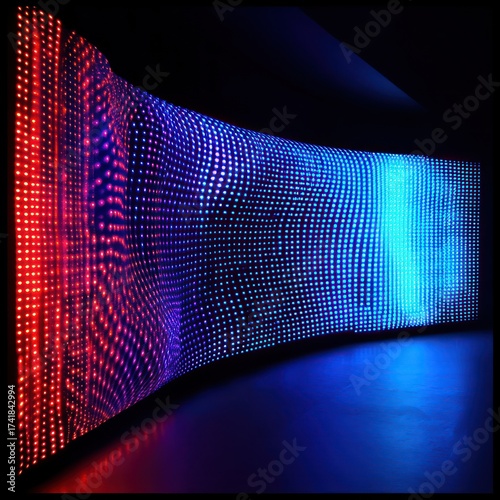 Abstract curved led display with red to blue gradient in a dark room creating a light show