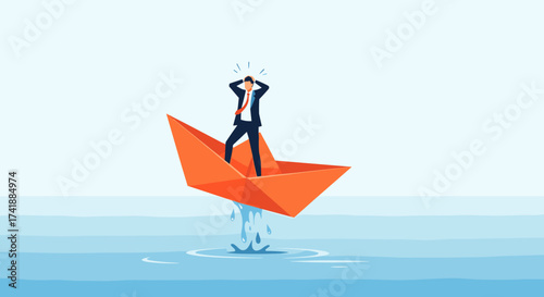 A stressed businessman stands on a sinking paper boat in the middle of the ocean with water splashing out.