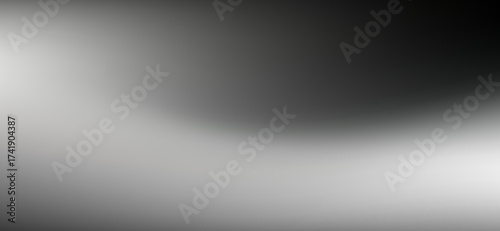 A seamless and soft grey gradient gracefully transitions from luminous white to deep charcoal, creating a smooth and captivating backdrop with subtle tonal shifts