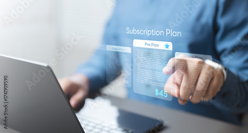Quadro em tela Man choosing digital subscription plan on virtual screen, representing online services, recurring billing, membership management, and pricing options for digital platforms and SaaS products