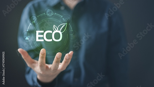 Open hand holding glowing ECO icon with green energy symbols, representing renewable energy, solar power, cost savings, ROI, and sustainable solutions for environmental protection.
