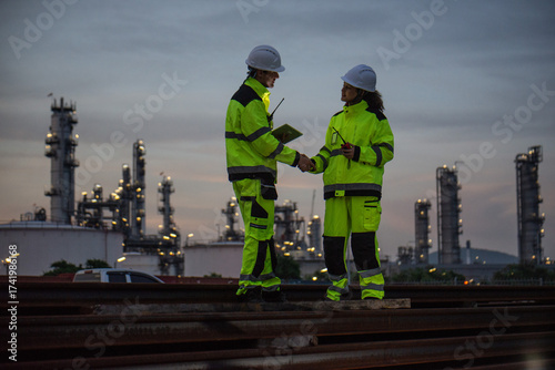 Petroleum engineers are working at petroleum refineries.