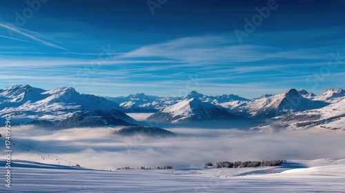 Majestic panorama of snow capped mountains and low lying fog in winter aerial scenic landscape blue sky