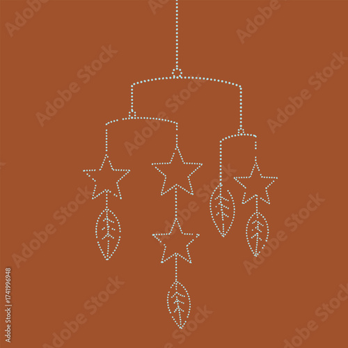 Decorative hanging ornament featuring star and leaf motifs suspended from a dotted string on a warm brown