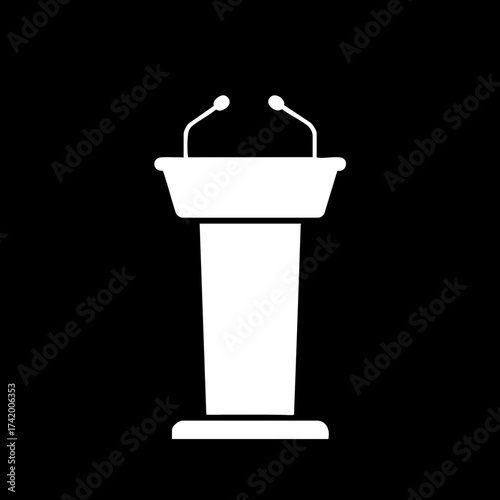 White podium with two microphones for public speaking and presentations.