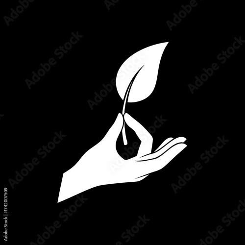 Hand holding delicate leaf in spiritual mudra gesture symbolizing nature wellness.