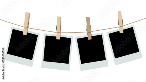 Vintage blank photographs clipped to string using wooden clothespins